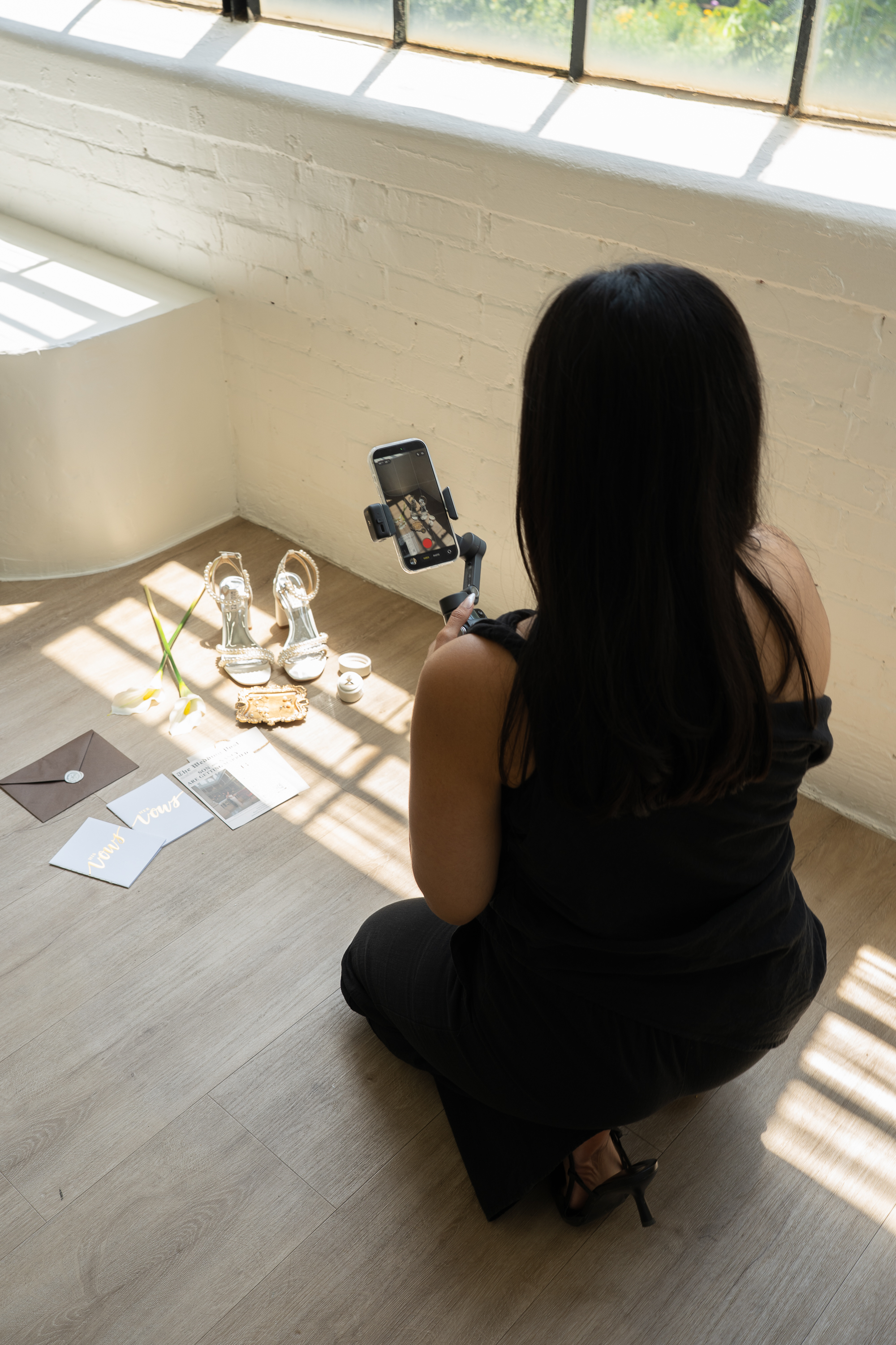 Content creator filming behind-the-scenes wedding moments on iPhone